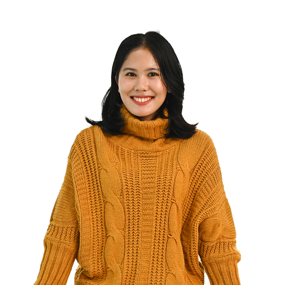 a women smiling with orange sweater